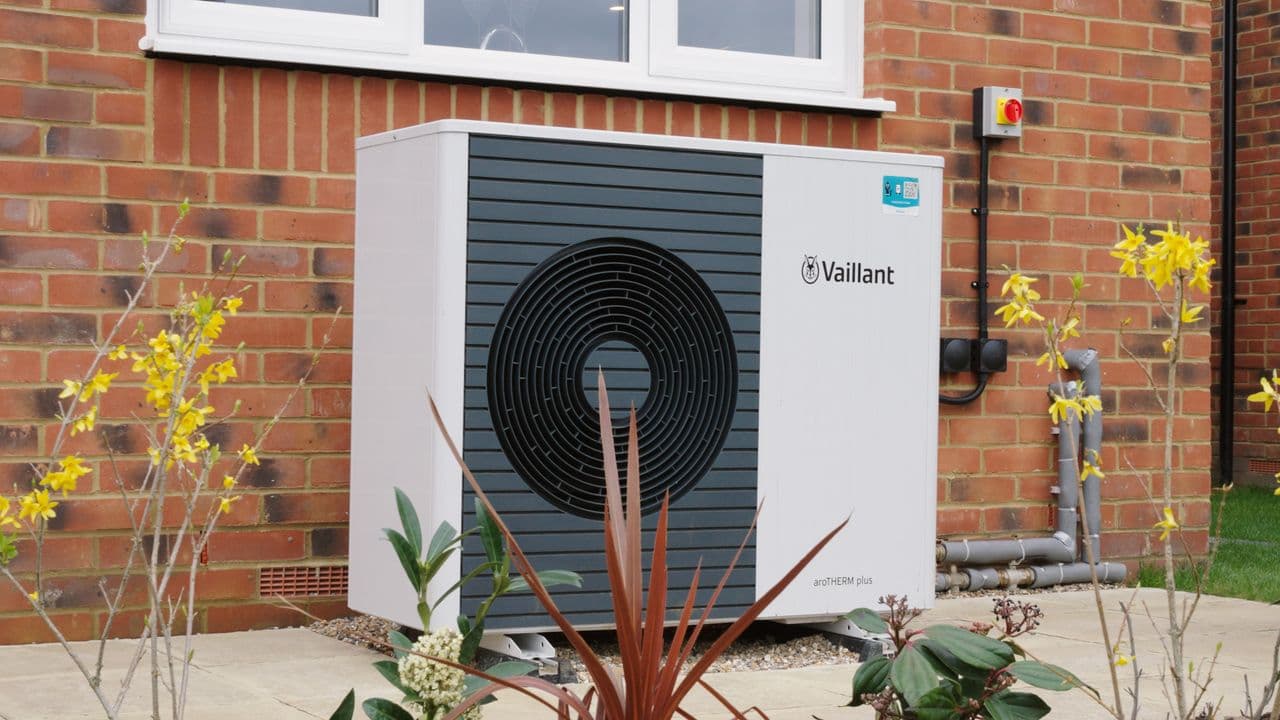 An air source heat pump installed beside a house